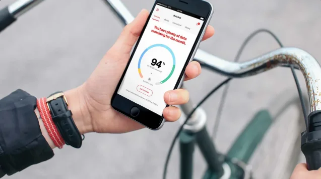 A hand holding a phone showing the MyVerizon data hub with the headline You have plenty of data remaining for the month above a 94 percent dial.